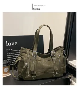 Close-up of olive green tote bag with matte leather texture and metal eyelet details