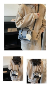 Structured two-tone square bag in grey and black with a white plush ball accessory