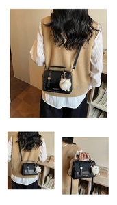 Multiple views of a black saddle bag with gold hardware and a cute sheep charm