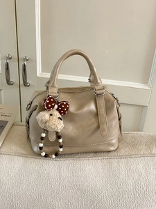 Light brown Boston handbag in soft faux leather featuring a cute cream plush bear charm