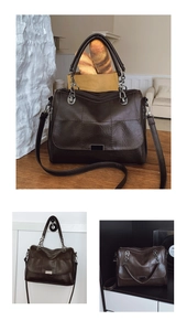 Close-up of dark brown vintage leather boston bag with quilted stitching and metal buckle