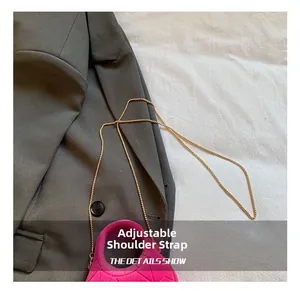 Detail showing fuchsia quilted mini handbag with gold chain on a blazer
