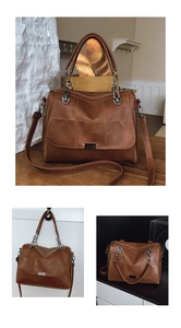 Detail of vintage brown plaid Boston bag with soft leather texture and metal hardware