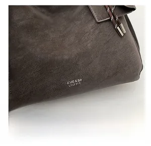 Detail showing vintage lychee texture grey leather tote with white logo and rope accents