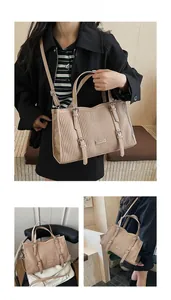 Detail view of pink pleated tote bag with stylish buckles and adjustable strap