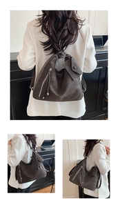 Detail of charcoal grey hobo bag with detachable mini pouch and zipper tassel detail