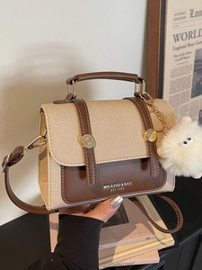 Retro canvas and brown leather crossbody bag with top handle and plush monster charm