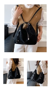 Detail of black PU leather hobo backpack with side zippers and a mini coin purse pendant