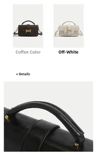 Detailed view of the vintage leather handbag featuring a golden H-shaped metal clasp