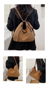 Detail view of large brown retro tote bag showing soft leather texture and side zipper