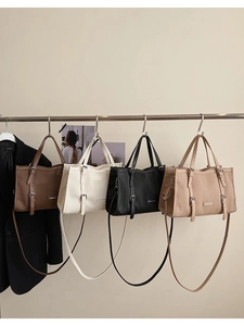 Group display of vertical pleated tote bags in brown, white, black and beige variants