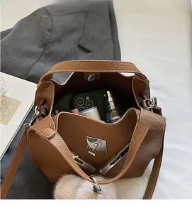 Internal view of brown litchi leather bucket bag showing spacious storage for essentials