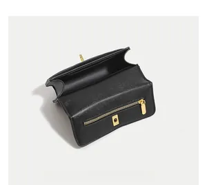 Interior view of black caviar leather flap bag with gold zipper and main compartment