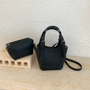 Detail of black lychee grain bucket bag set with matching coin purse and leather strap