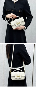 Detail view of cream lychee texture crossbody bag with golden H buckle decoration