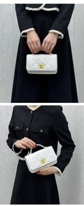 Detail of white quilted crossbody bag featuring a gold buckle and luxury leather texture
