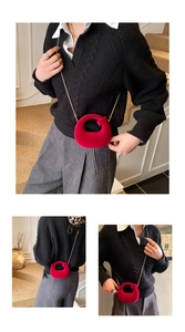 Detail of red velvet doughnut crossbody bag with elegant gold metal chain strap