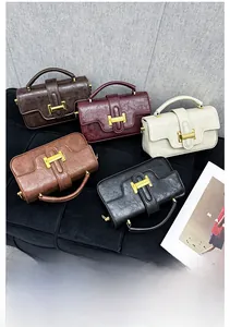 Detail shot of five vintage textured leather handbags with iconic gold H-buckle