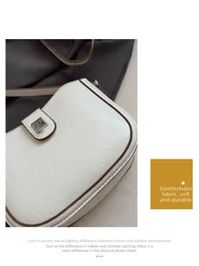 Macro detail of creamy faux leather bag with crackle texture and brown oil edges