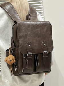 Retro dark brown PU leather backpack with vintage buckle straps and plush bear charm