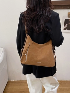 Brown large capacity hobo shoulder bag for women with stylish tassel and side zipper