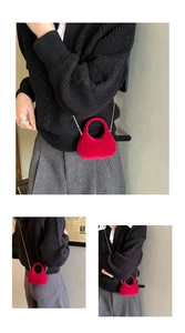 Macro detail of red quilted velvet mini handbag with elegant gold metal chain strap