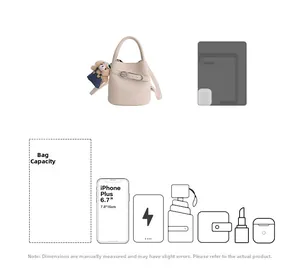 Detail view of cream leather bucket bag showing inner capacity for phone and accessories