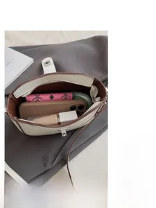 Internal view of bucket bag showing capacity for phone, wallet and cosmetics