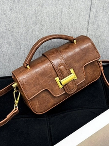 Vintage dark brown leather handbag with gold metal clasp and detachable shoulder strap