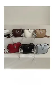 Collection of small square crossbody bags in six colors with star charms and metal locks