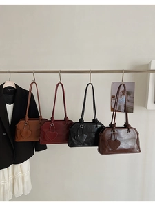 Detail of vintage tote bags with unique knotted straps and leather heart charms