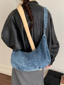 Vintage blue denim hobo bag featuring large capacity and adjustable wide shoulder strap
