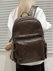 Retro dark brown PU leather backpack for students with plush ball charm and large capacity