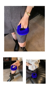 Detailed macro view of vibrant blue velvet circular handbag with elegant gold chain strap