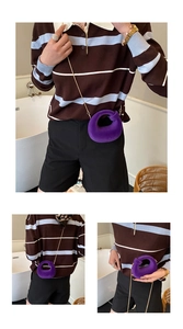 Detailed view of purple plush donut bag featuring unique knot design and gold chain strap