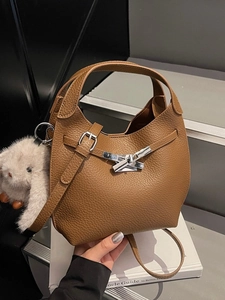 Brown litchi leather bucket handbag with silver buckle and plush rabbit charm detail