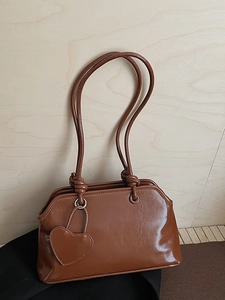 Retro caramel brown PU leather tote bag with heart charm and wavy edge detail