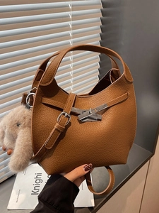 Brown lychee leather bucket bag with silver metal lock and plush rabbit charm