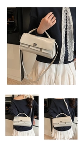 Detail of creamy white flap handbag with silver twist lock and decorative lace strap