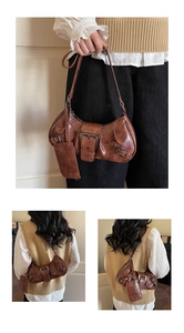 Detail view of vintage brown baguette bag with metal buckle and detachable mini pouch