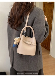 Litchi pattern leather bucket bag in apricot with a cute plush bear charm detail