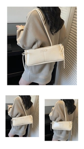 Detail of cream underarm bag showing bow knots and FASHION & BAGS metal plate