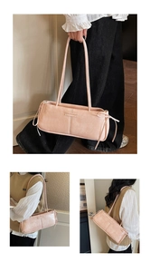 Detail of pink underarm bag with decorative side bows and metallic fashion brand logo