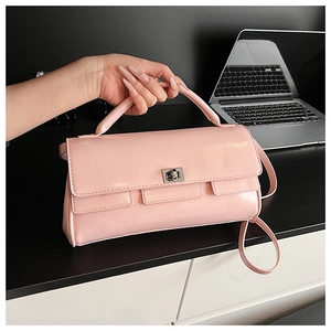 Close-up of pink fashion handbag with silver twist lock on an office desk