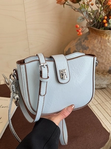 Retro light blue bucket crossbody bag with brown trim and silver fox charm detail