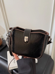 Vintage black oil wax leather bucket bag with silver buckle and brown trim detail