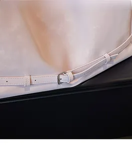Close-up of pink leather tote strap featuring high-gloss silver metal buckle detail