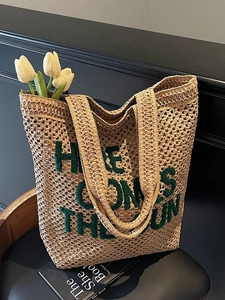 Large beige woven straw tote bag with Here Comes The Sun embroidery for summer beach trips