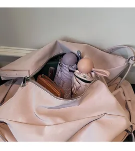 Internal view of the spacious pink tote bag showing large capacity for umbrellas and wallet