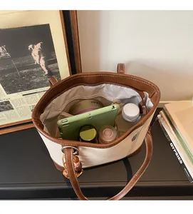 Interior detail of large canvas and leather tote bag showing spacious storage capacity